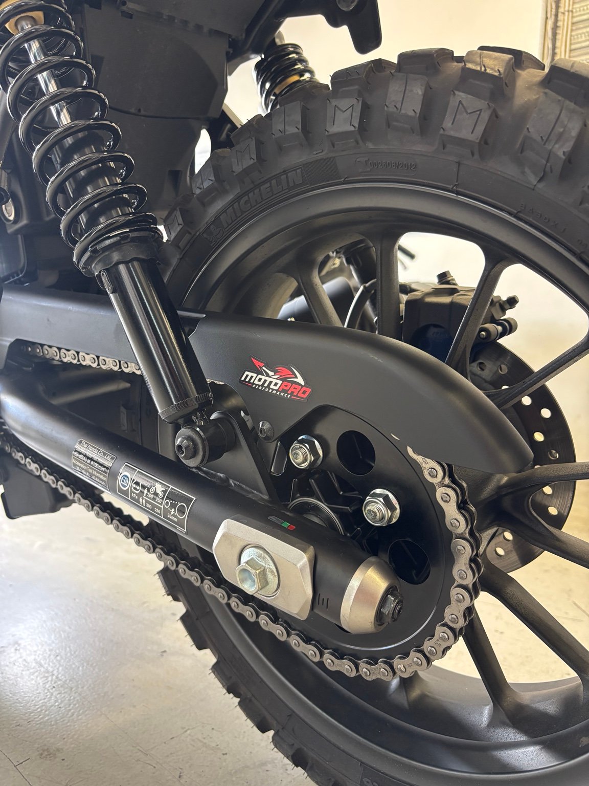 Motopro chain guard sticker, chain and rear wheel detail