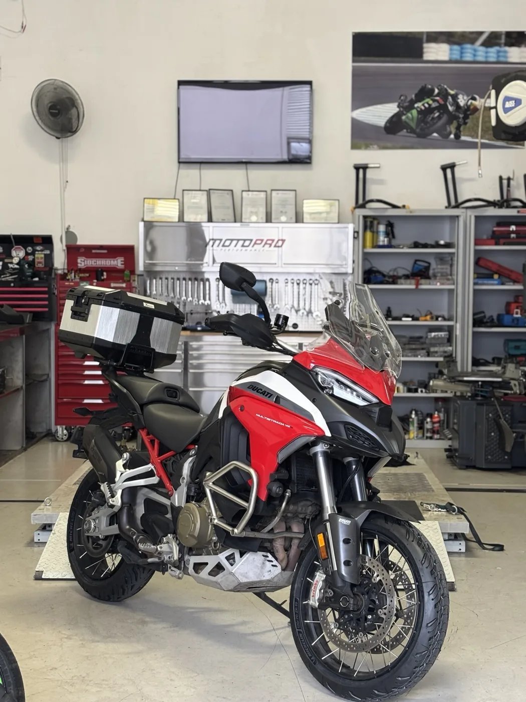 Adventure motorcycle on a lift in the Motopro workshop