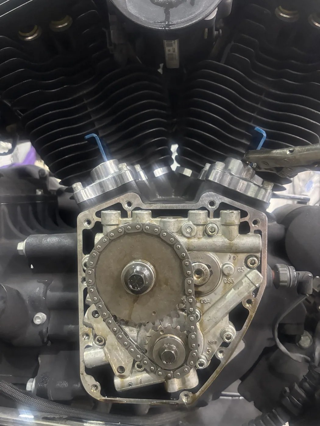 Close-up of motorcycle engine components during workshop work