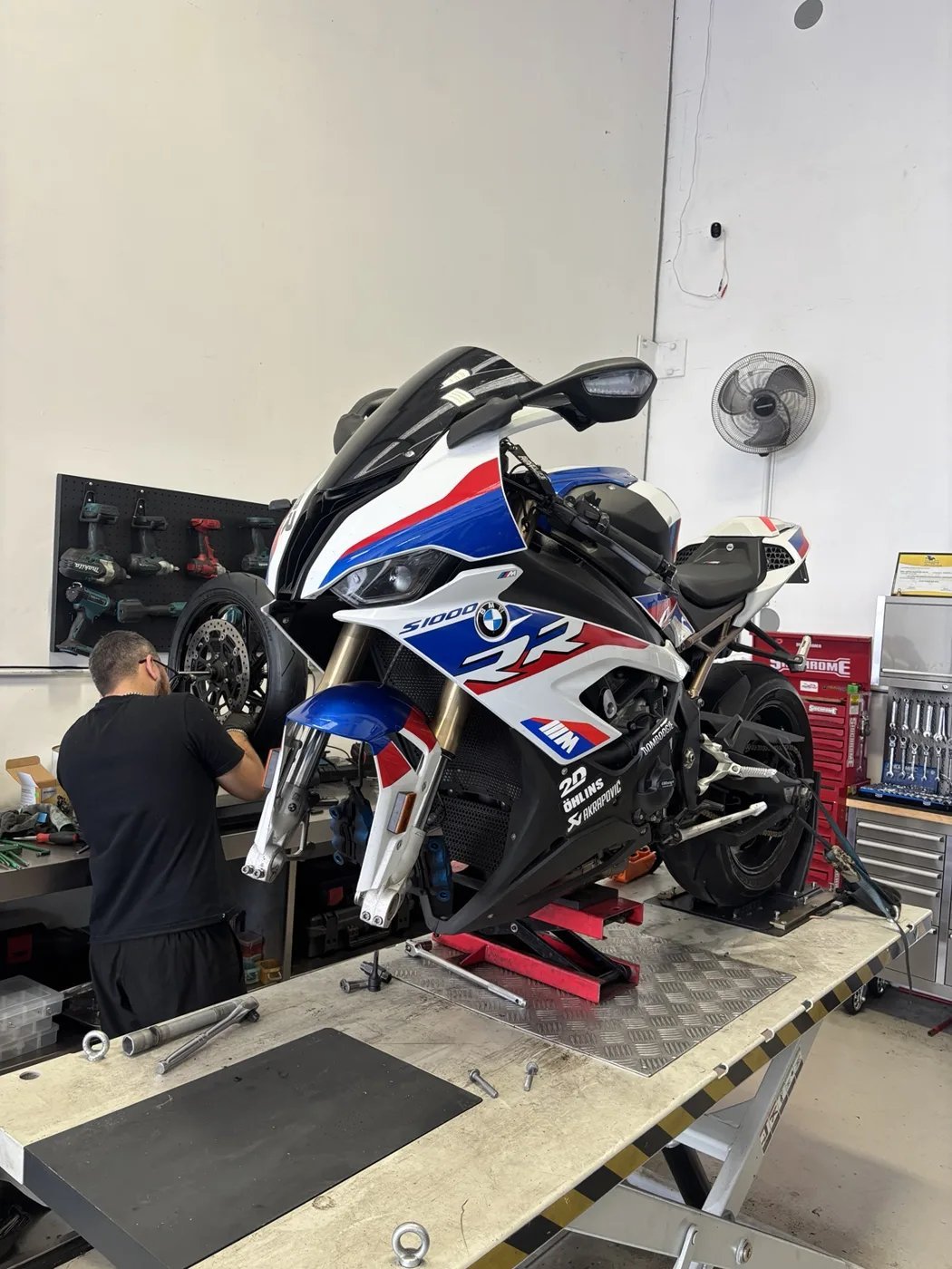 Sports motorcycle on a workshop lift during mechanical preparation